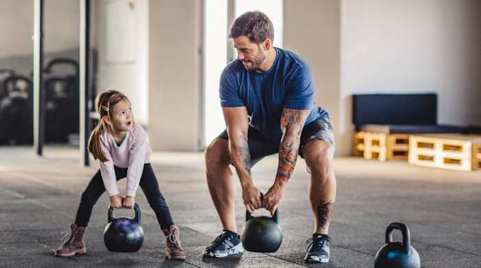 dad working out with daughter